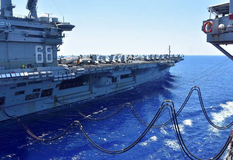 FILE PHOTO: U.S. Navy aircraft carrier USS Nimitz receives fuel from the Henry J. Kaiser-class fleet replenishment oiler USNS Tippecanoe