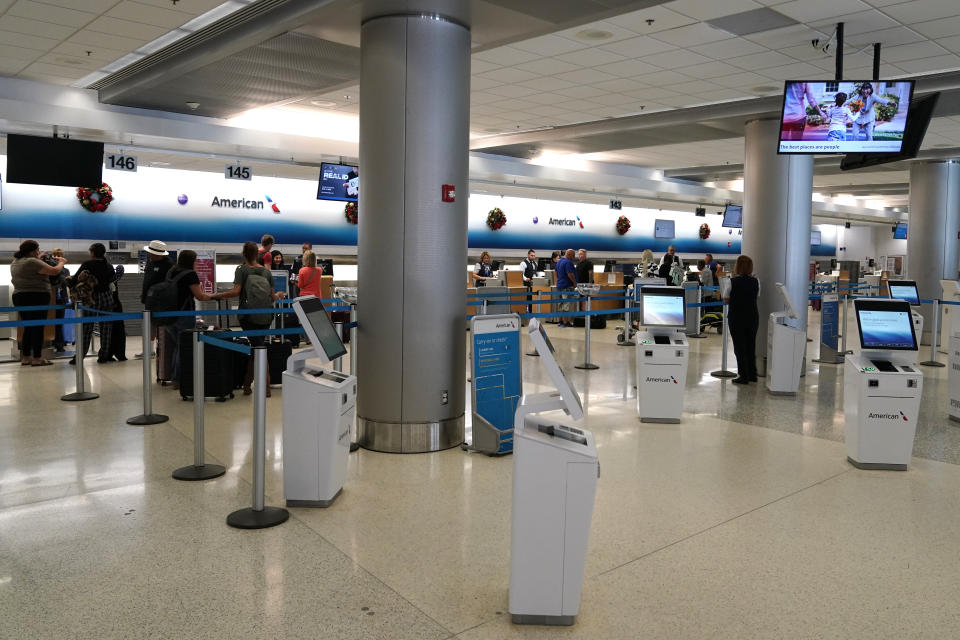 Travelers wait in line at an American Airlines ticket counter at Miami International Airport ahead of the Thanksgiving holiday, Wednesday, Nov. 22, 2023, in Miami. (AP Photo/Lynne Sladky)