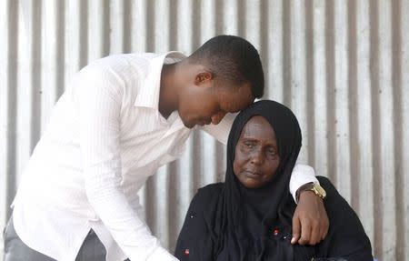 Ali Noor comforts Faduma Farah Guled as she waits for information about her son Mohamed Farah, who is missing in the Mediterranean Sea following the recent shipwreck at an unknown location between Libya and Italy, during a Reuters interview at their home in Somalia's capital Mogadishu, April 22, 2016. REUTERS/Feisal Omar