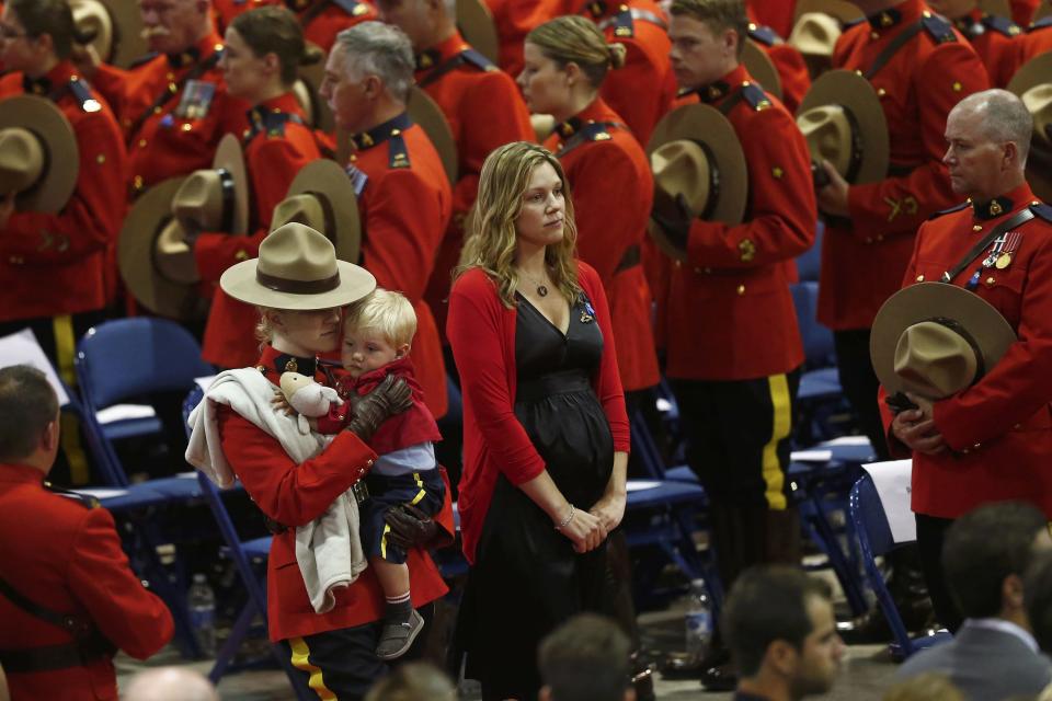 Rachael, the widow of RCMP K-9 officer David Ross, one of three officers who were killed last week, arrives with their son Austin at a regimental funeral Moncton250