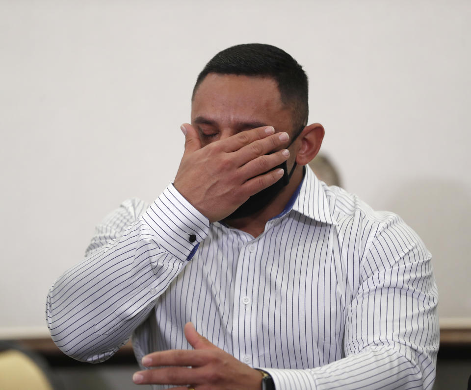 Houston Police officer Felipe Gallegos tears up as lawyer Rusty Hardin speaks during a press conference at Hilton Americas, Tuesday, Jan. 26, 2021, in Houston. Gallegos has been charged with murder and is among additional officers who have been indicted as part of an ongoing investigation into a Houston Police Department narcotics unit following a deadly 2019 drug raid, prosecutors announced Monday. (Karen Warren/Houston Chronicle via AP)