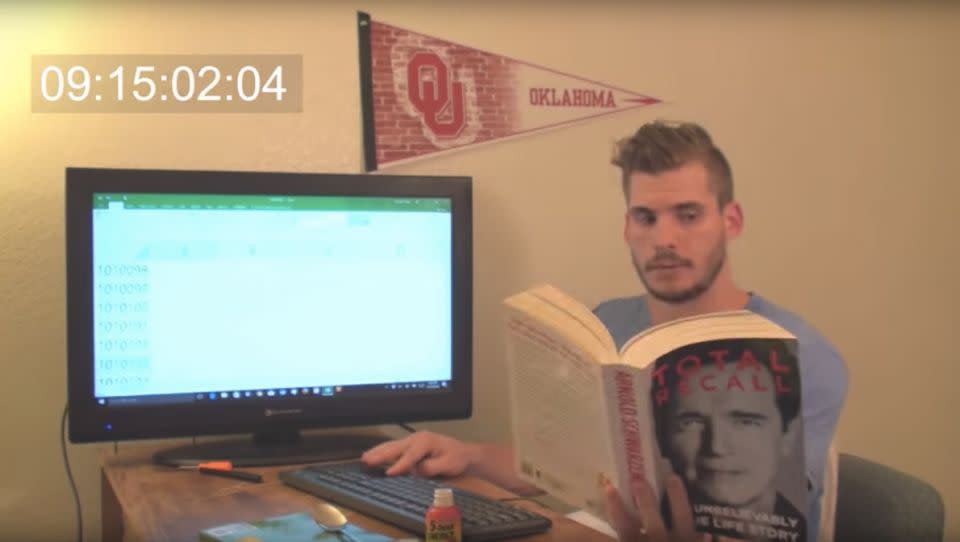 Mr Hobbs sits at his desk and passes the time by reading books, listening to music and talking on his mobile. Source: YouTube