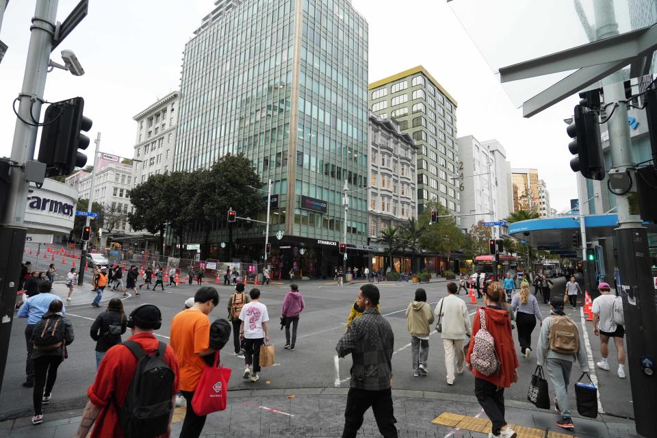 People cross a street in central Auckland. New Zealand, a liberal democracy that is increasingly multicultural, is grappling with how to guarantee Indigenous rights without excluding others.  (Saphora Smith)