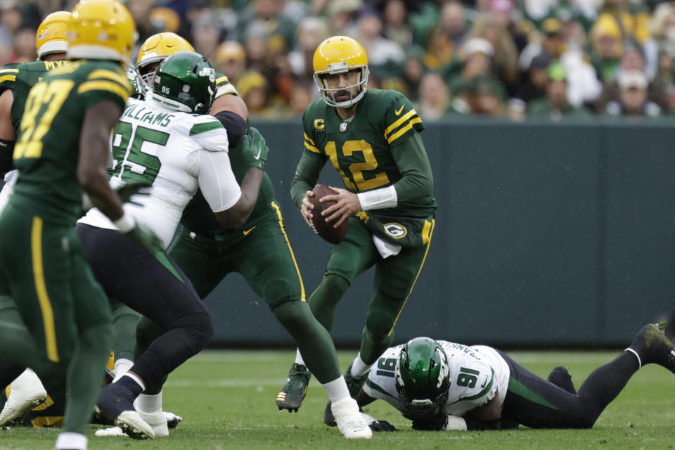 Green Bay Packers quarterback Aaron Rodgers scrambles during the first half of an NFL football game against the New York Jets, Sunday, Oct. 16, 2022, in Green Bay, Wis. (AP Photo/Matt Ludtke)