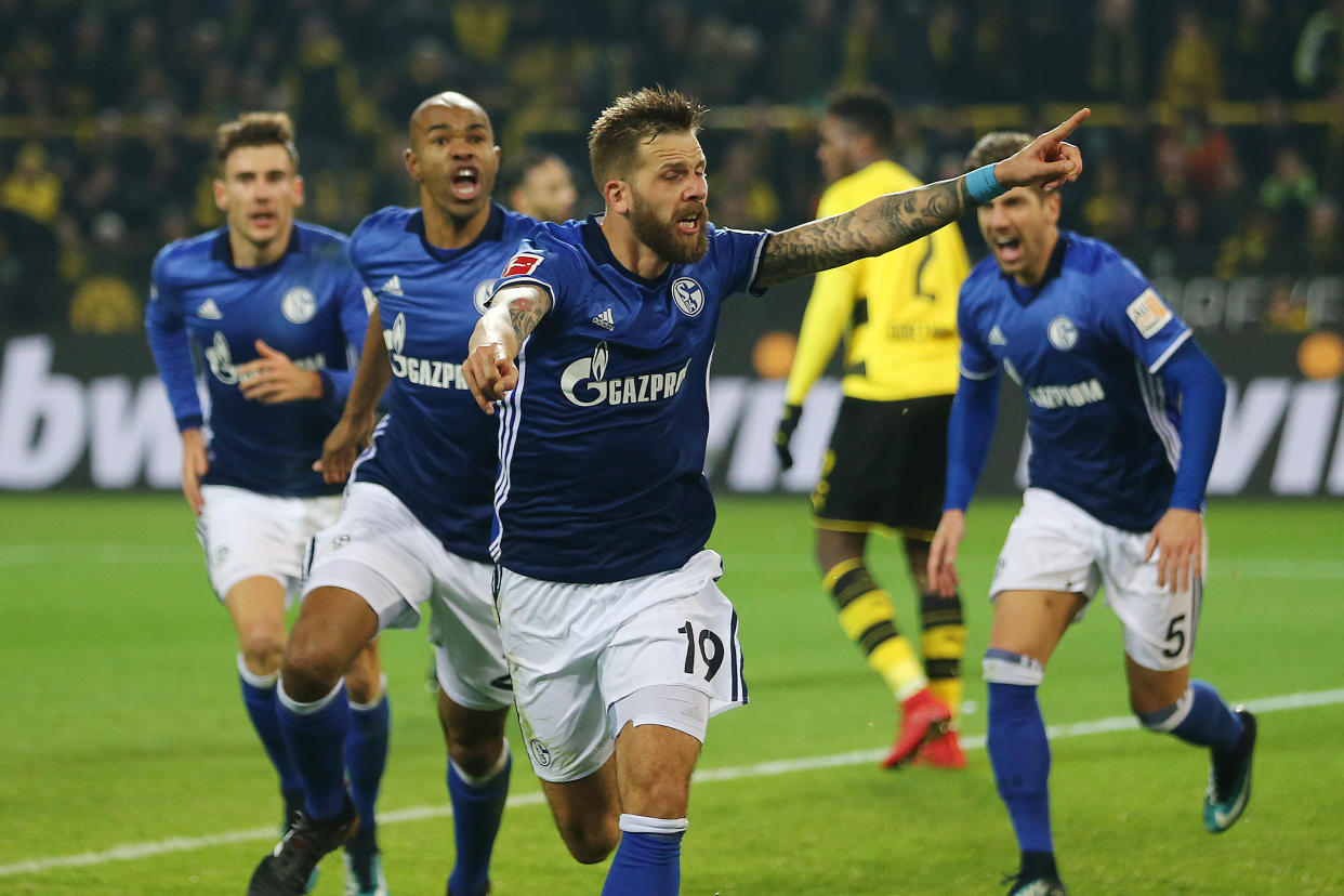 Guido Burgstaller of Schalke (19) celebrates after Naldo (left behind him) completed Schalke’s wild four-goal comeback. (Getty Images)