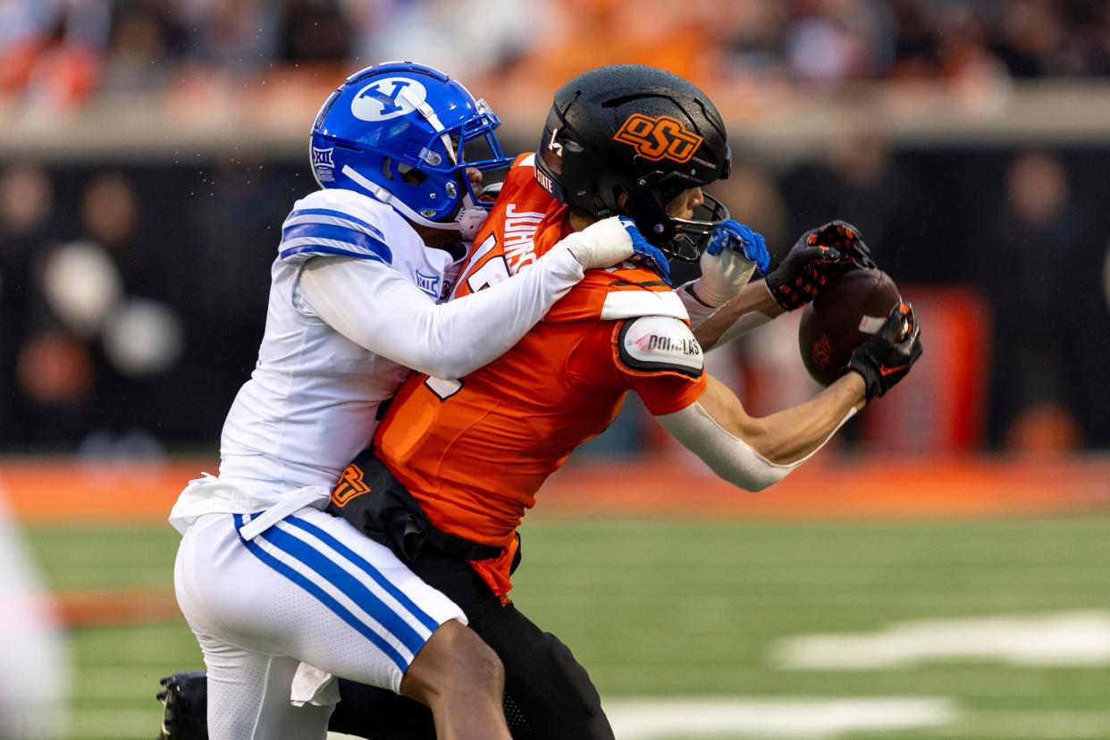 BYU cornerback Kamden Garrett (7) guards Oklahoma State wide receiver Leon Johnson III (17) in the first half of an NCAA college football game Saturday, Nov. 25, 2023, in Stillwater, Okla. (AP Photo/Mitch Alcala)