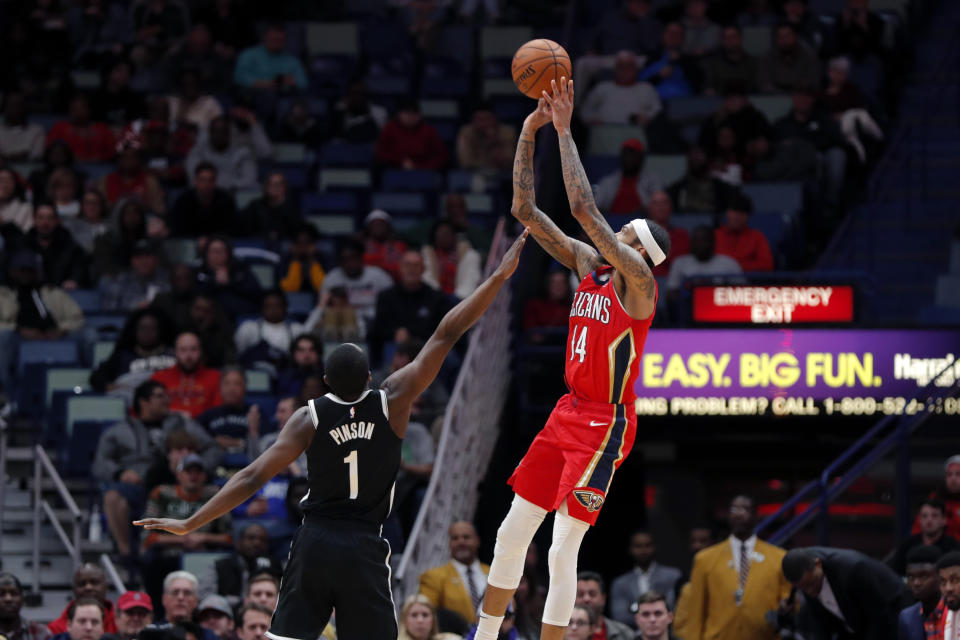 New Orleans Pelicans forward Brandon Ingram (14) attempts a 3-pointer over Brooklyn Nets guard Theo Pinson (1) in the second half of an NBA basketball game in New Orleans, Tuesday, Dec. 17, 2019. The Nets won in overtime 108-101. (AP Photo/Gerald Herbert)