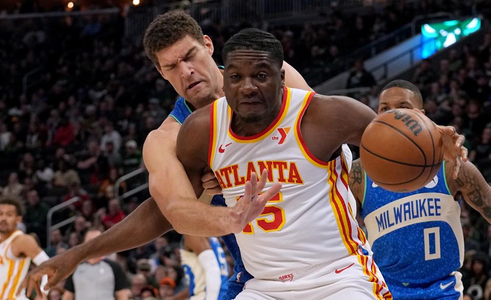 Bucks center Brook Lopez defends Atlanta Hawks center Clint Capela during the half Saturday at Fiserv Forum.