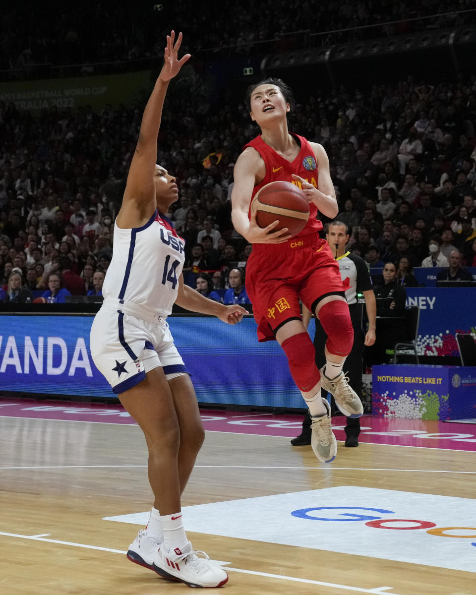 China's Wang Siyu runs past United States' Betnijah Laney to score a goal during their game at the women's Basketball World Cup in Sydney, Australia, Saturday, Sept. 24, 2022. (AP Photo/Mark Baker)