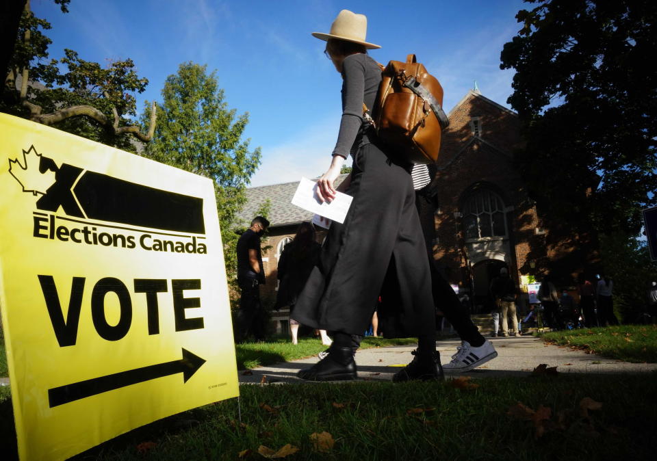 People start to line up early for the Canadian general election before polls open in west-end Toronto for the Monday, Sept. 20, 2021. (Graeme Roy/The Canadian Press via AP)