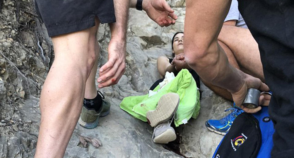 Rescuers tended to the injured hiker after her date had to ‘rush off to work’. Source: Brian Coulter/Saltwater Ecology