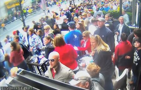 A still image captured from surveillance video at the Boston Marathon shows the scene moments before a second bomb exploded as a man, marked with a circle by prosecutors (top R) and identified by them as defendant Dzhokhar Tsarnaev, moves rapidly away from the spot near the finish line of the race on April 15, 2013, in this handout video provided by the U.S. Attorney's Office in Boston, Massachusetts on March 9, 2015. REUTERS/U.S. Attorney's Office/Handout via Reuters