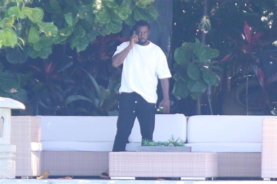 Diddy was seen on his phone amid the raids from the Feds. SplashNews.com