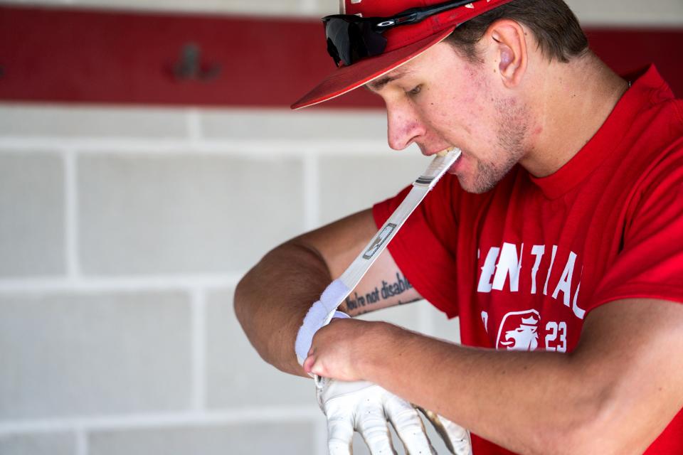 Colton DeRocher puts on his batting glove at the Central College baseball field on Wednesday, July 19, 2023 in Pella, Iowa.