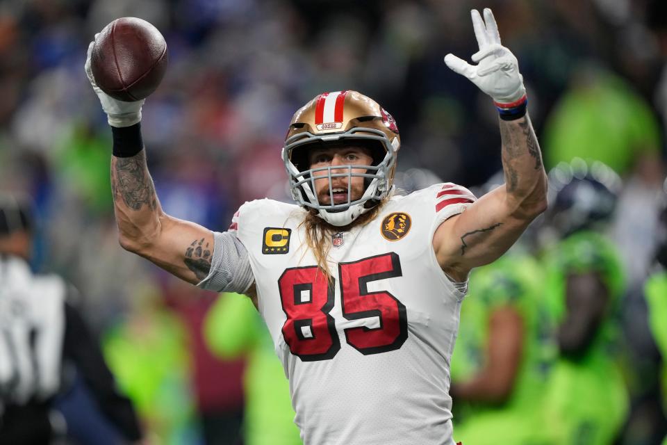 San Francisco 49ers tight end George Kittle (85) celebrates a touchdown by teammate running back Christian McCaffrey during the first half of an NFL football game against the Seattle Seahawks, Thursday, Nov. 23, 2023, in Seattle.