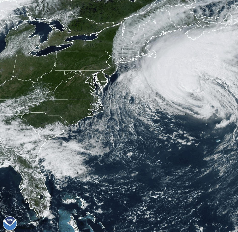 This Friday, Sept. 15, 2023, 3:11 p.m. EDT satellite image provided by the National Oceanic and Atmospheric Administration shows Hurricane Lee, right, near New England and Eastern Canada. A tropical storm warning extended from Maine through Massachusetts, with powerful gusts forecast to arrive late in the day in southern New England. Maine and coastal Nova Scotia and New Brunswick are expected to see the brunt of the storm's remnants on Saturday. (NOAA via AP)