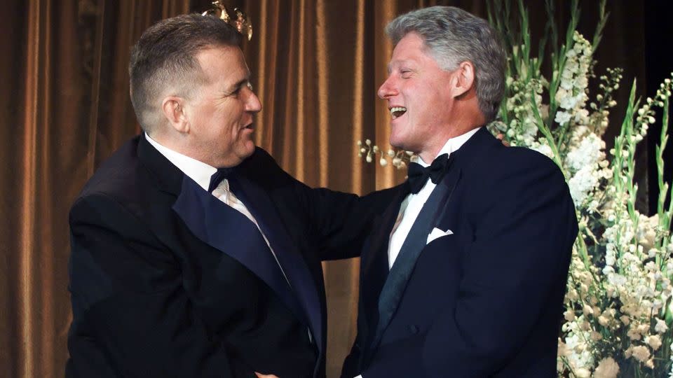 U.S. President Bill Clinton (R) shakes hands with LGBTQ activist David Mixner. - Reuters