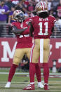 San Francisco 49ers wide receiver Deebo Samuel, left, celebrates after scoring a touchdown with wide receiver Brandon Aiyuk (11) during the second half of an NFL football game against the Minnesota Vikings in Santa Clara, Calif., Sunday, Nov. 28, 2021. (AP Photo/Tony Avelar)