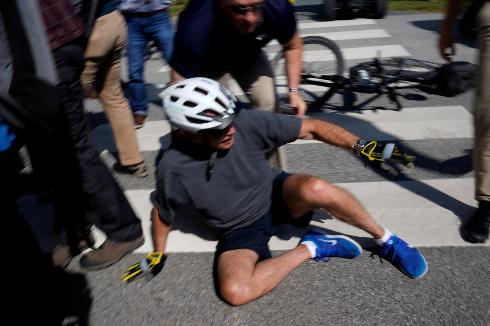 Biden on the ground after falling off his bike