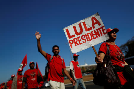 FILE PHOTO: Brazil's former President Luiz Inacio Lula da Silva's supporters walk during the Free Lula March in Brasilia, Brazil, August 14, 2018. REUTERS/Adriano Machado/File photo