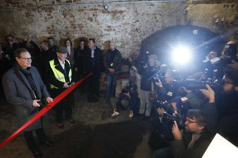 Berlin Mayor Michael Mueller official opens an escape tunnel, underneath the Berlin Wall which divided the city for 28 years during the Cold War, for public for the first time in Berlin, Germany, Thursday, Nov. 7, 2019.The tunnel was built by a group of people who had escaped earlier from communist East Germany to West Berlin. They wanted to help friends and family to flee to the West, too, but days before it was finished, East German officials discovered and destroyed it. (AP Photo/Markus Schreiber)