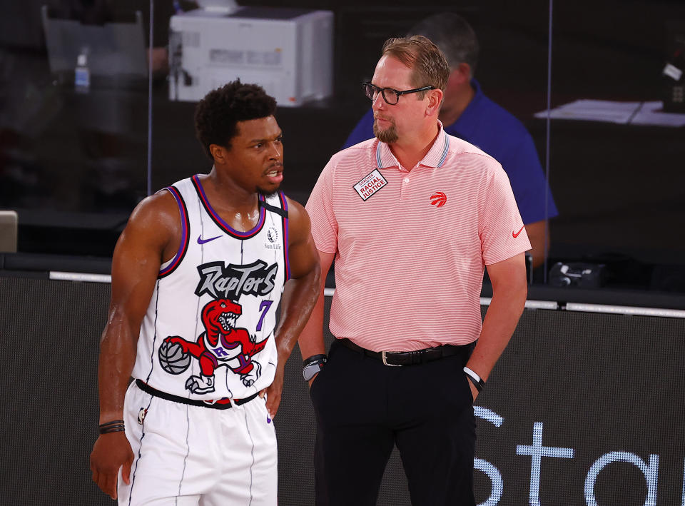 Toronto Raptors head coach Nick Nurse, right, talks with Kyle Lowry (7) during the first quarter of an NBA basketball game against the Memphis Grizzlies, Sunday, Aug. 9, 2020, in Lake Buena Vista, Fla. (Kevin C. Cox/Pool Photo via AP)