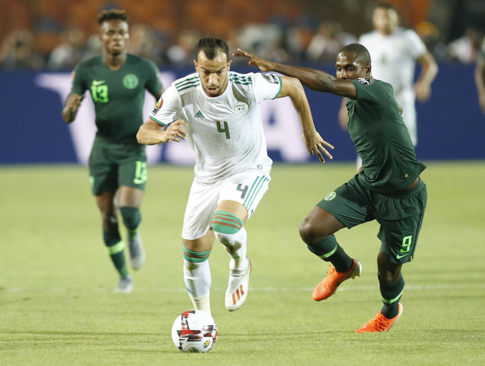 Algeria's Djamel Eddine in action in front of Nigeria's Odin Ighalo during the African Cup of Nations semifinal soccer match between Algeria and Nigeria in Cairo International stadium in Cairo, Egypt, Sunday, July 14, 2019. (AP Photo/Ariel Schalit)