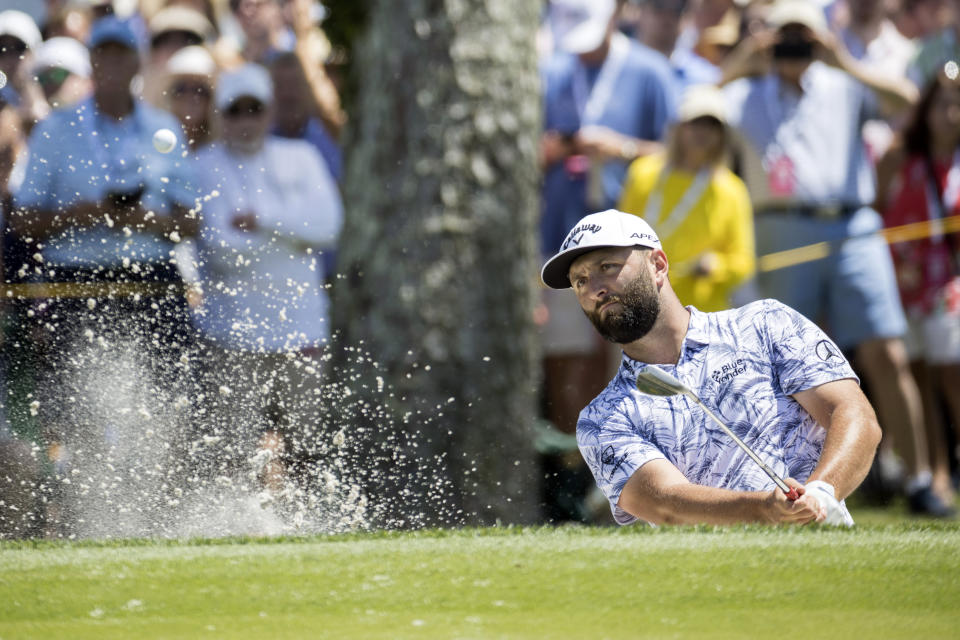 Jon Rahm, of Spain, hits out of a bunker on the ninth green during the second round of the RBC Heritage golf tournament, Friday, April 14, 2023, in Hilton Head Island, S.C. (AP Photo/Stephen B. Morton)