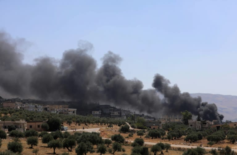 Smoke rises from buildings that were hit by reported Russian air strikes in the rebel-held Syrian town of Muhambal, southwest of the city of Idlib