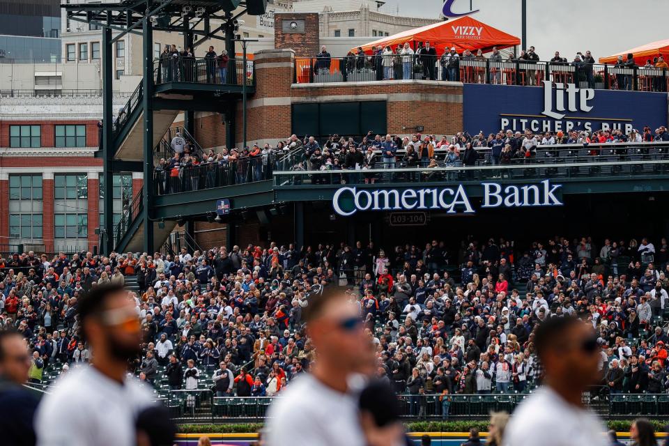 Baseball fans during the singing of national anthem of the home opening day game between Detroit Tigers and Oakland Athletics at Comerica Park in Detroit on Friday, April 5, 2024.