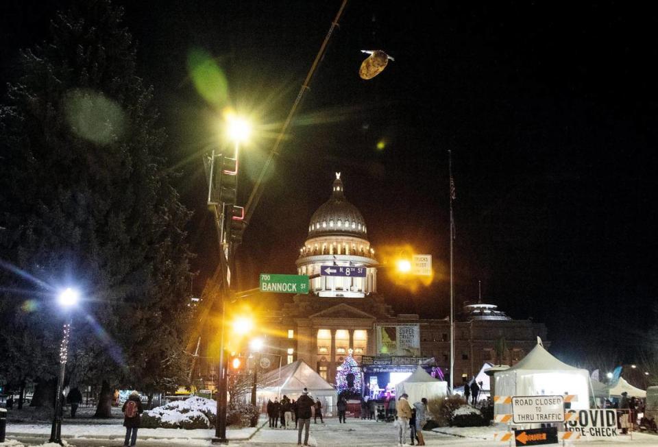 A large potato with wings is lifted into the air by a crane at the start of the Idaho Potato Drop on Dec. 31, 2021.