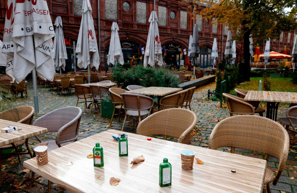 <p>The remains of the last party are seen on the table of a closed cafe at Berlin's Hackescher Markt</p> (AFP via Getty Images)