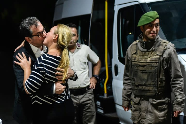 Cumhuriyet editorial director Kadri Gursel kisses his wife after being released from prison in September, but four of his colleagues remained behind bars