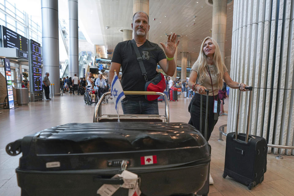 Passengers arriving from the Indian Ocean island nation of Seychelles that made an emergency stop in Saudi Arabia react upon landing at Ben Gurion Airport in Lod, near Tel Aviv, Israel, Tuesday, Aug. 29, 2023. Israeli media reported the Air Seychelles flight carrying 128 passengers was forced to land Monday because of an electrical malfunction. Israel's Foreign Ministry said the passengers spent the night at an airport hotel in Jeddah and were flown back by the airline on an alternate plane. (AP Photo/Tsafrir Abayov)