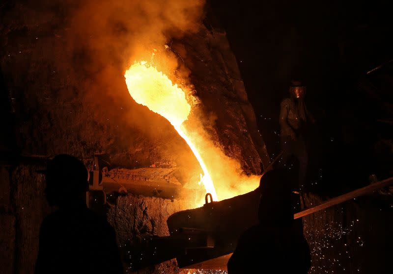 FILE PHOTO: A worker observes an electric furnace inside a steel factory on the outskirts of Jammu