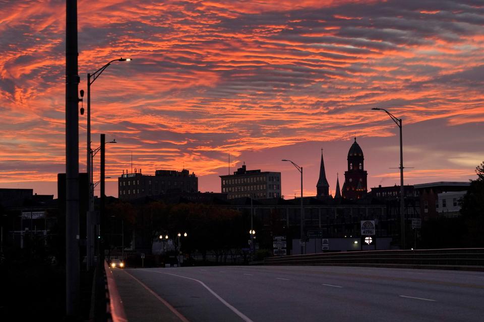 The skyline of in Lewiston, Maine is seen at dawn, Thursday, Oct. 26, 2023. Residents have been ordered to shelter in place as police continue to search for the person of interest of Wednesday's mass shooting at a local bar.