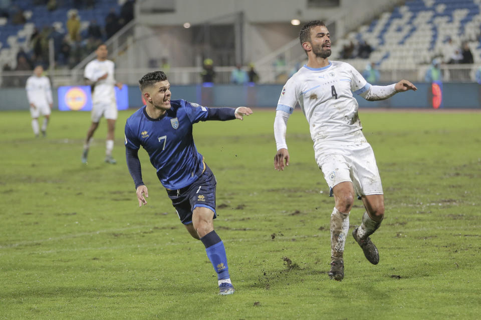 Kosovo's Milot Rashica, left, celebrates after scoring the opening goal during the Euro 2024 group I qualifying soccer match between Kosovo and Israel at the Fadil Vokrri stadium in Pristina, Kosovo, Sunday, Nov. 12, 2023. (AP Photo/Visar Kryeziu)