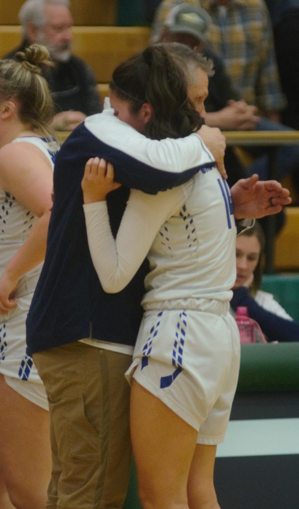 Ava Schultz shares a moment with head coach and dad, Pat Schultz, after being subbed out during a regional final matchup between Gaylord St. Mary's and Glen Lake on Thursday, March 9 at Traverse City West High School in Traverse City, Mich.