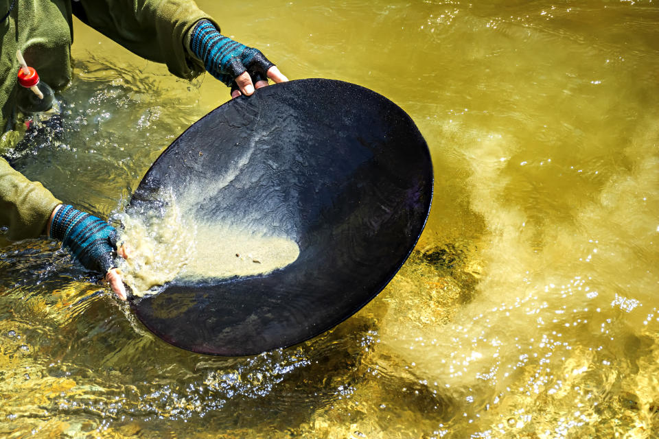 Gold panning, or simply panning, is a form of placer mining and traditional mining that extracts gold from a placer deposit using a pan.
