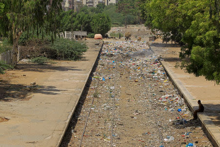 A man rests in the shade on the platform of the abandoned Nazimabad station in Karachi, Pakistan, May 23, 2017. REUTERS/Caren Firouz