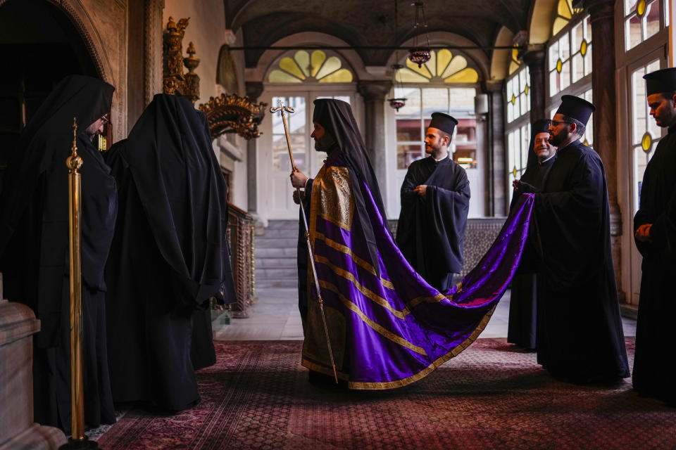 Christian Orthodox Metropolitan Maximos of Selyvria, center, arrives to lead the service of the Holy Passion at the Patriarchal Church of St. George in Istanbul, Turkey, Thursday, April 13, 2023. About 300 million Orthodox Christians around the world will celebrate on Sunday, April 16, the most important religious holiday in the Orthodox Christian calendar. (AP Photo/Francisco Seco)