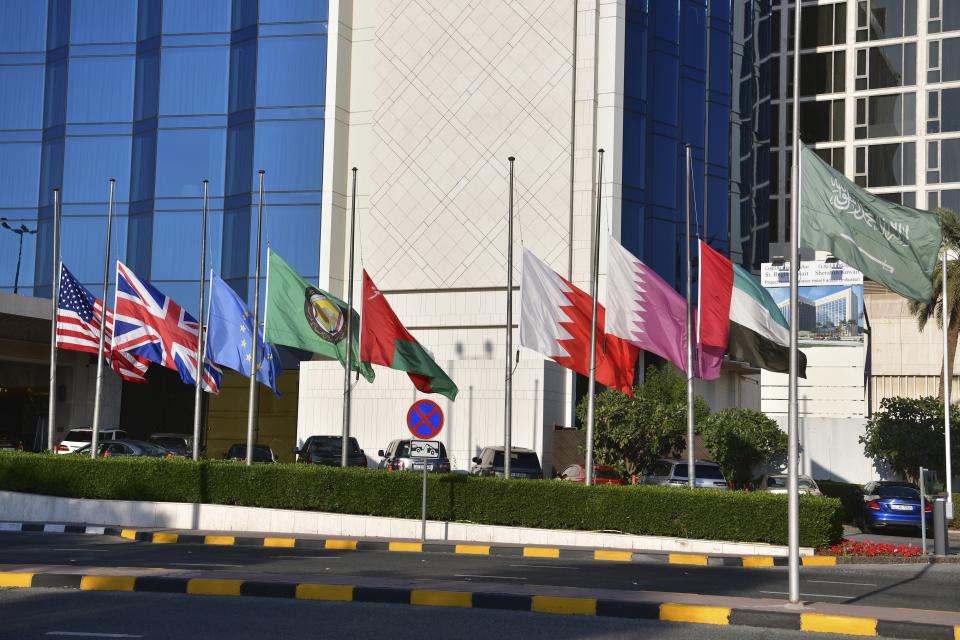 National flags of different countries are in half mast in front of a hotel, after the death of the Emir of Kuwait Sheikh Nawaf Al Ahmad Al Sabah, in Kuwait, Saturday, Dec. 16, 2023. Kuwait's ruling emir, the 86-year-old Sheikh Nawaf Al Ahmad Al Sabah, died Saturday after a three-year, low-key reign focused on trying to resolve the tiny, oil-rich nation's internal political disputes. (AP Photo/Jaber Abdulkhaleg)