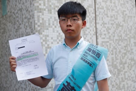 Joshua Wong, secretary-general of Hong Kong's pro-democracy Demosisto party, poses before submitting his application for the race in the 2019 District Council Election, at the Southern District Office in Hong Kong