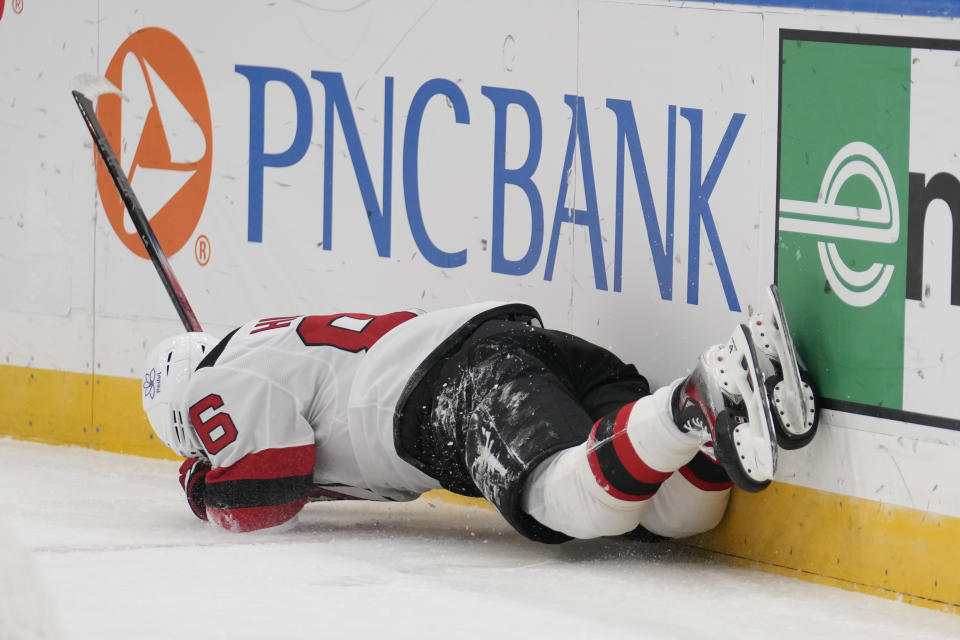 New Jersey Devils' Jack Hughes slams against the boards during the first period of an NHL hockey game against the St. Louis Blues Friday, Nov. 3, 2023, in St. Louis. (AP Photo/Jeff Roberson)