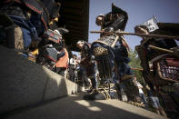 Men dressed as samurai warriors in armor parade during the Kachiya Festival at Katori Shrine in Tokyo, May 5, 2016. The festival celebrates that the warlord Fujiwara Hidesato made for victory over warlord Taira no Masakado’s revolt in 940 during the Heian Period (794-1185) and then, Fujiwara dedicated a “kachiya” or victory arrow to the shrine. (Eugene Hoshiko/AP)