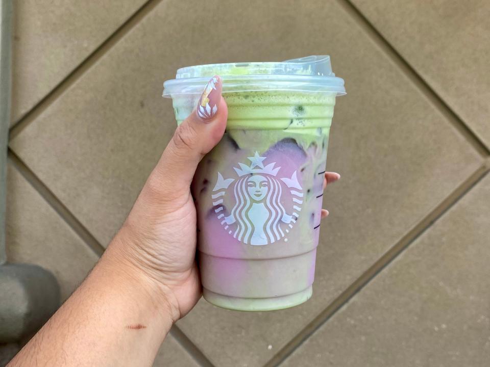 Melissa holding a Starbucks' Grande Witches' Cauldron Tea.