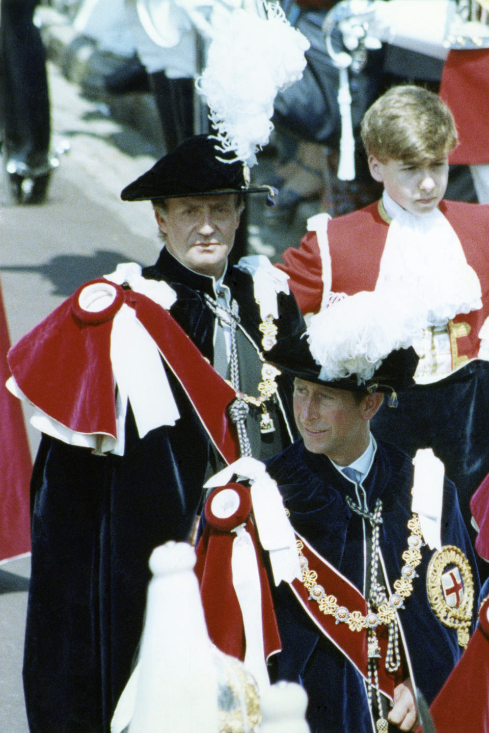 FILE - Britain's Prince Charles, lower right, is followed by newly installed extra Knight of the Garter, King Juan Carlos of Spain, background center, leaves St. George's Chapel, Windsor, England, on June 19, 1989. The Knights of the garter are the oldest order of English Christian chivalry. A playboy past that was once brushed under the carpet, a popular son whose telegenic family threatens to eclipse his own star, and endless leaks about his private life: Spain’s Juan Carlos I can empathize with the lot of Britain’s Charles III. The former Spanish head of state abdicated in disgrace in 2014, and serves as a warning for any European royal who wants their achievements on the throne, rather than torrid gossip, to be their lasting legacy. (AP Photo/Tony White)