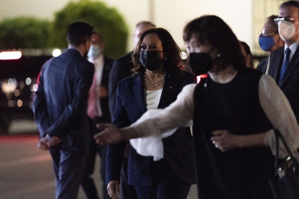 Vice President Kamala Harris, center, walks to her motorcade, Monday, June 7, 2021, at Benito Juarez International Airport, in Mexico City, after arriving from Guatemala. (AP Photo/Jacquelyn Martin)