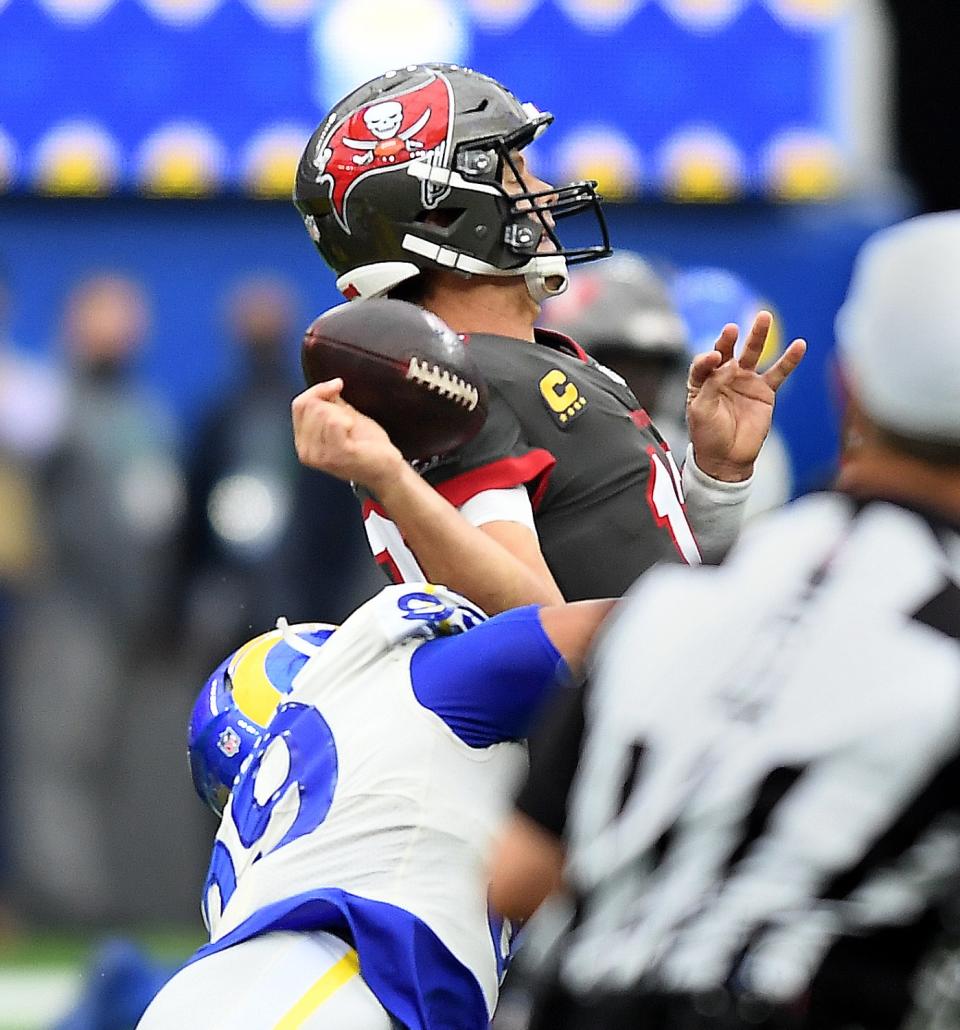 Rams defensive lineman Aaron Donald forces a fumble by Buccaneers quarterback Tom Brady,