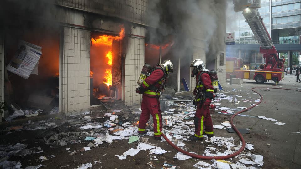 Firefighters extinguish a fire at an office of French bank Credit Mutuel in the Parisian suburb of Nanterre on June 29, 2023.  - Zakaria Abdelkafi/AFP/Getty Images